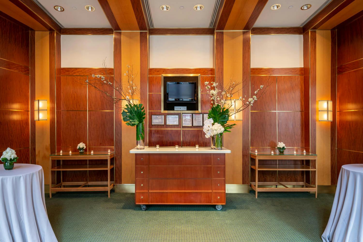 The Jacobs Room bar decorated with votive candles and dramatic green and white floral arrangements