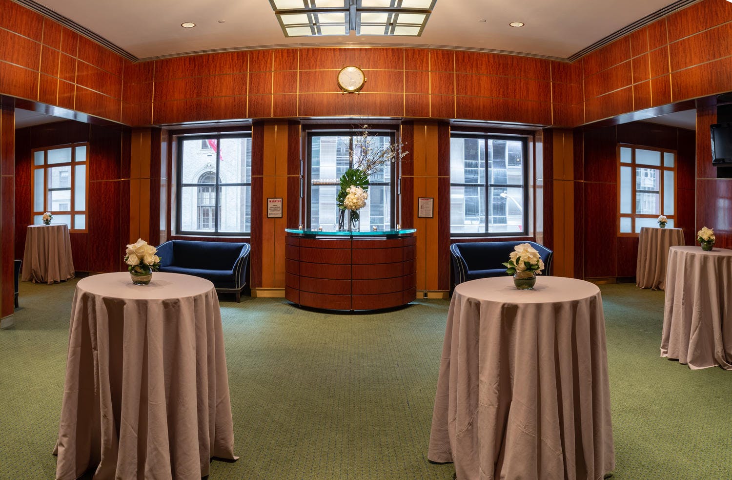 A wall of windows overlooking 57th Street in the Shorin Club Room, set for a reception