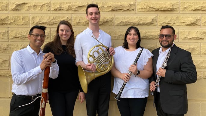 Musicians of Callaway Chamber Players pose together, smiling, with their instruments