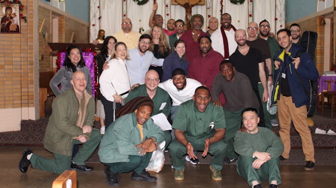 A group of people pose together in a chapel.