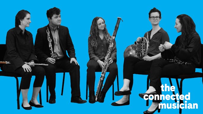 Members of Decoda seated with their instruments against a light blue background