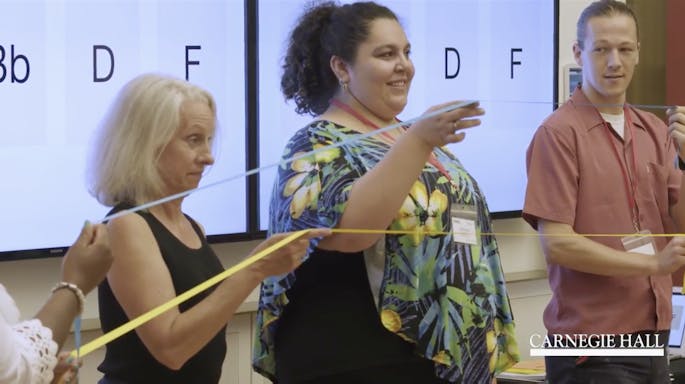 A group of teachers participate in an exercise together