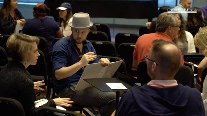 A group of teachers converse during a workshop