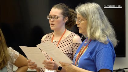 Two teachers sing together
