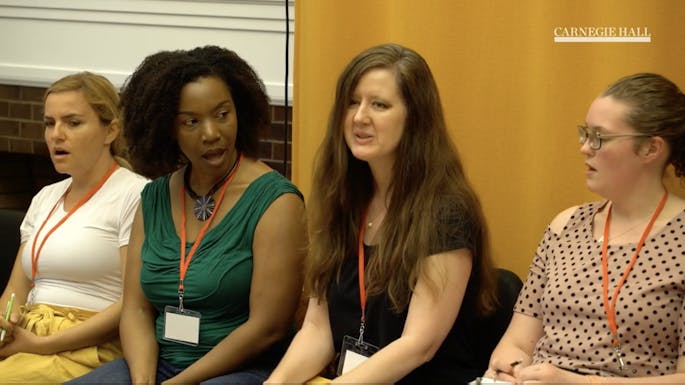 A group of four teachers sing together