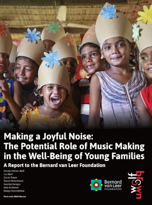A photo of smiling children wearing homemade hats.