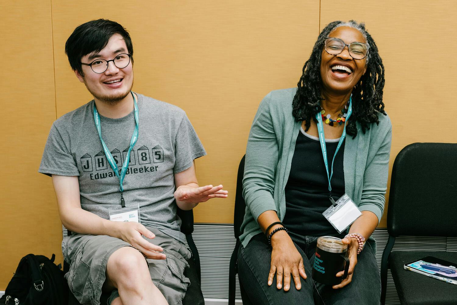 A woman laughs as a man seated next to her speaks