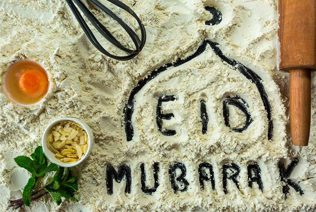 "EID MUBARAK" drawn in flour with cooking ingredients and a rolling pin
