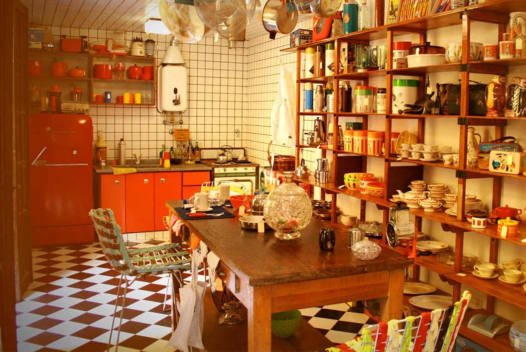 A kitchen with a dining table and shelves