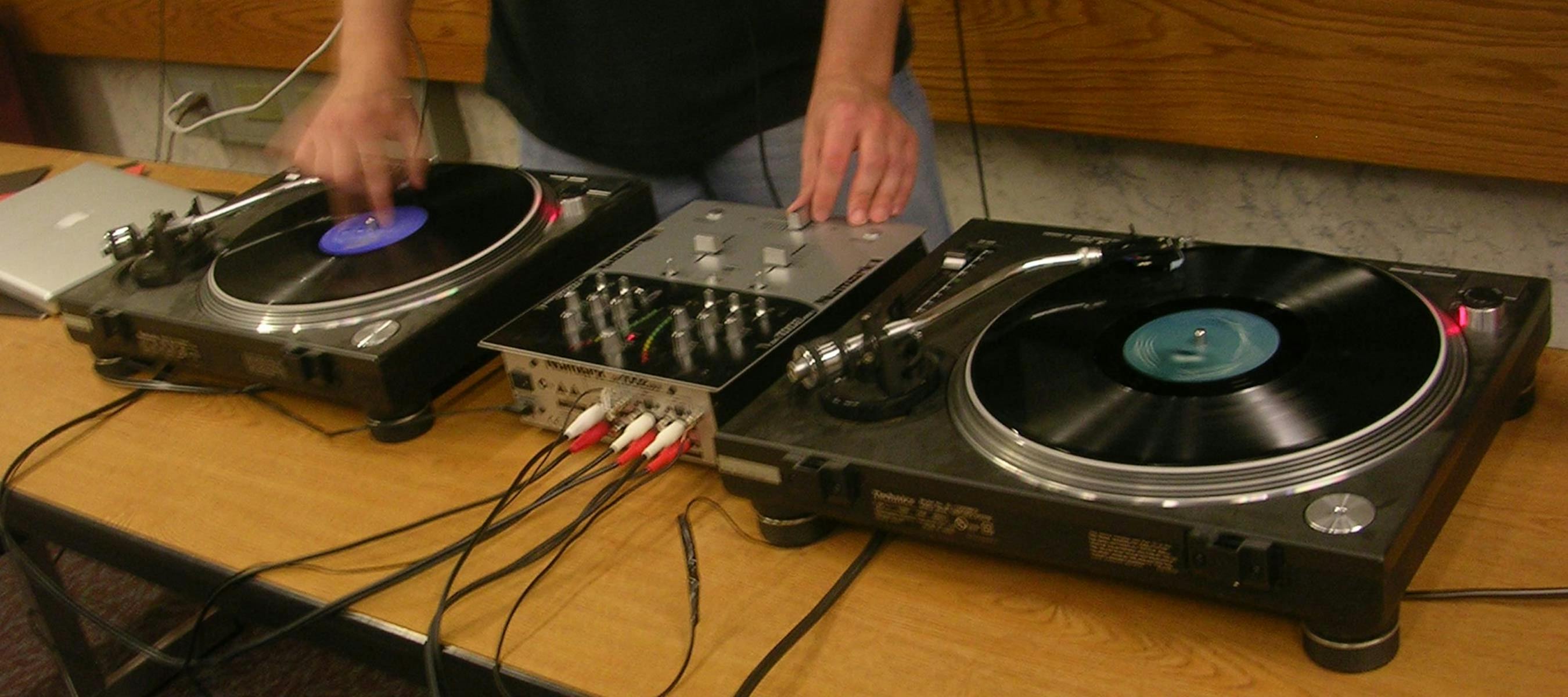 A deejay spins on two turntables