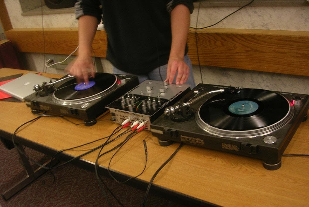 A deejay spins on two turntables
