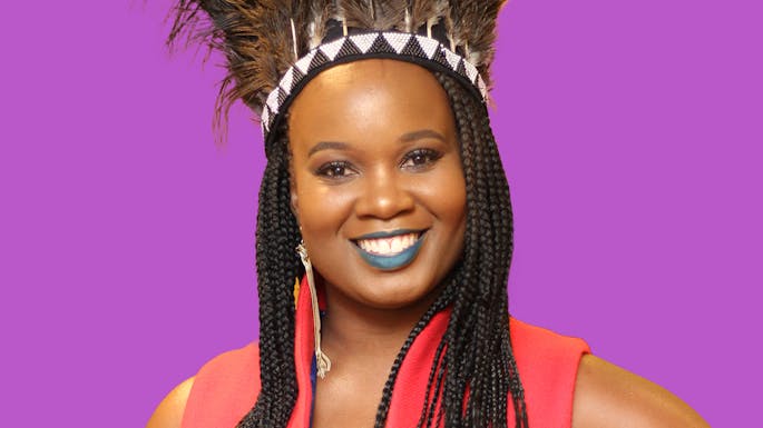 Tanyaradzwa wearing a feathered headdress against a purple background