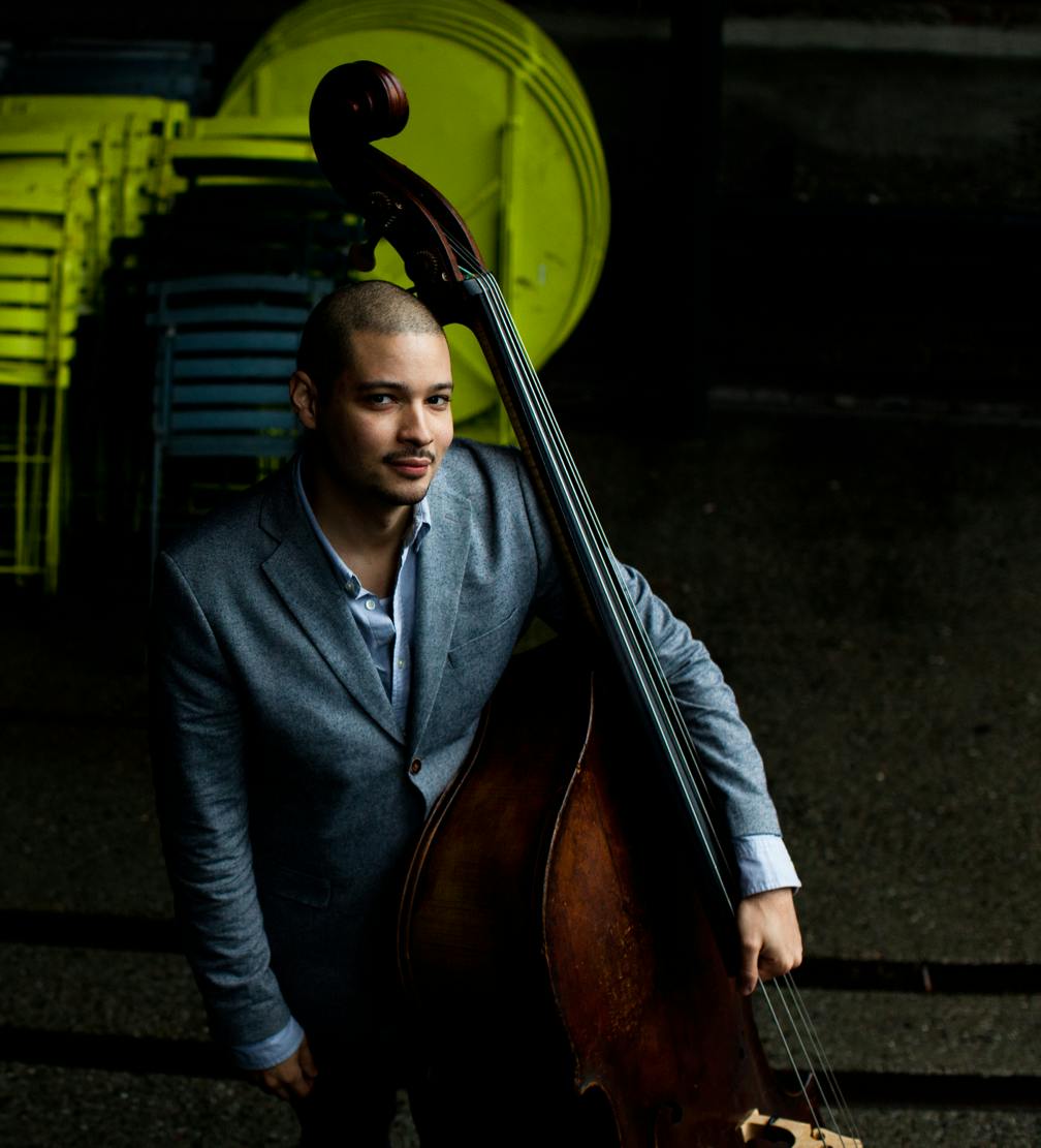 A man holds an acoustic bass