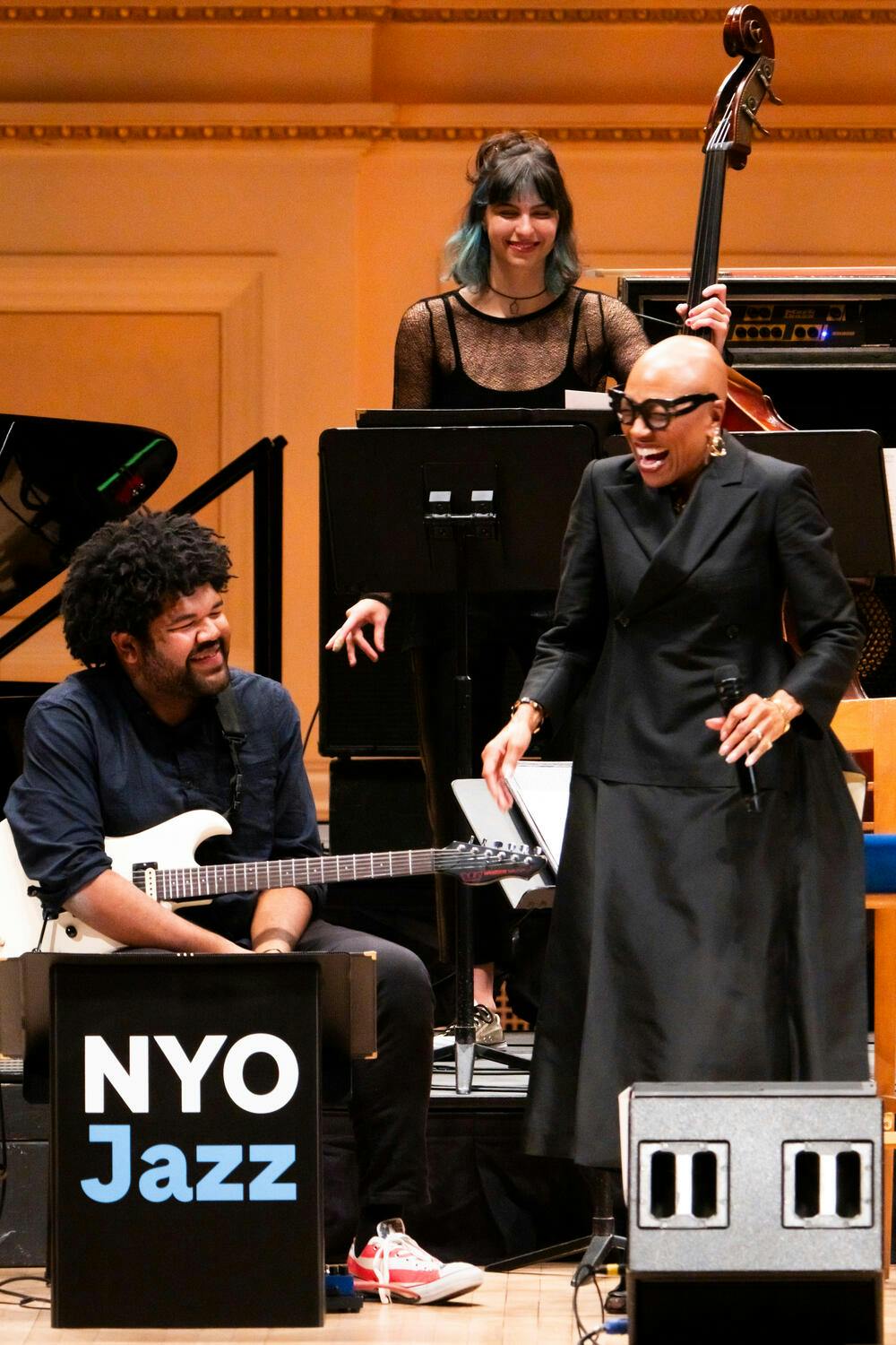 Dee Dee Bridgewater laughs with an NYO Jazz guitar player on stage
