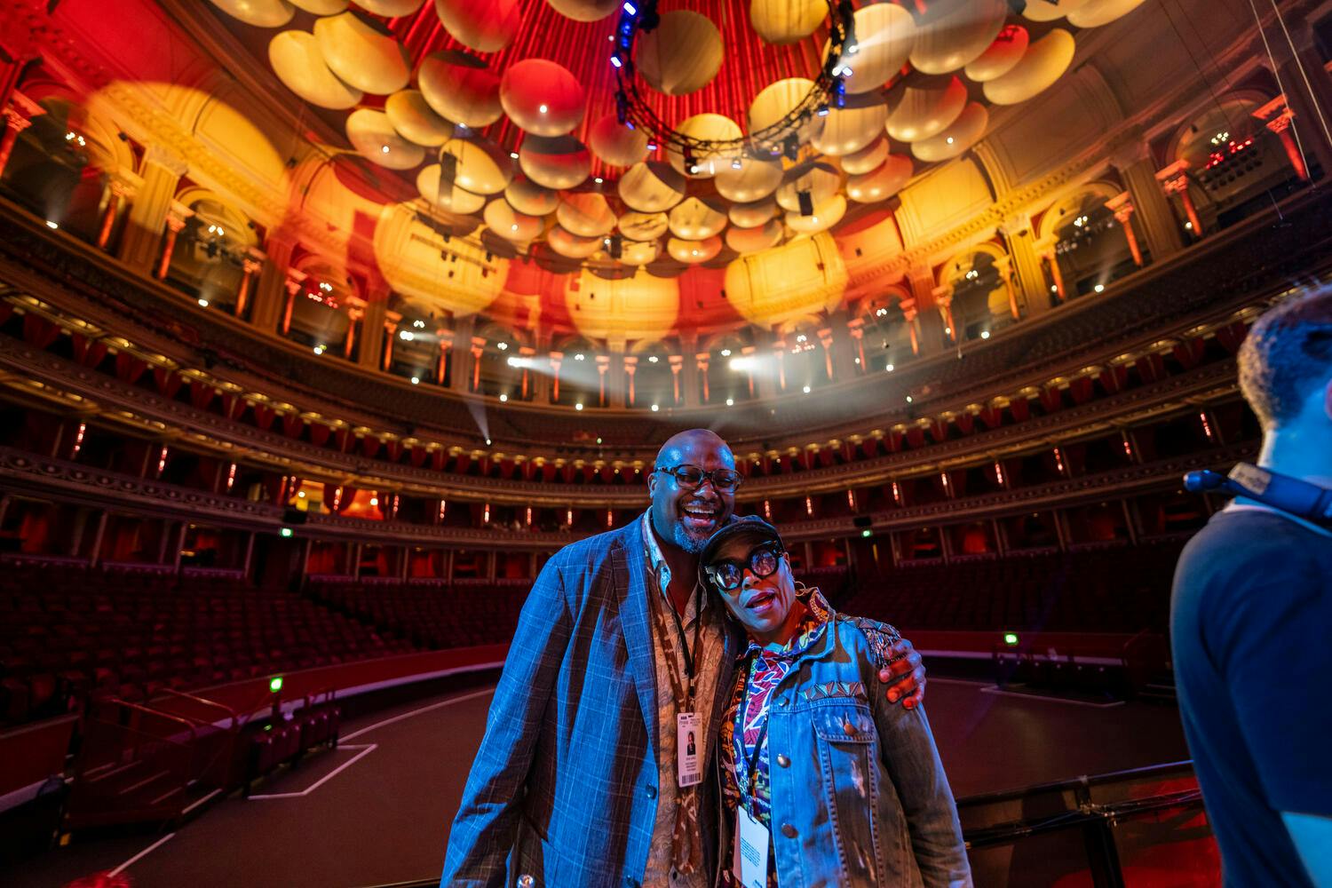 Sean Jones hugs Dee Dee Bridgewater under the colorful lights of Royal Albert Hall