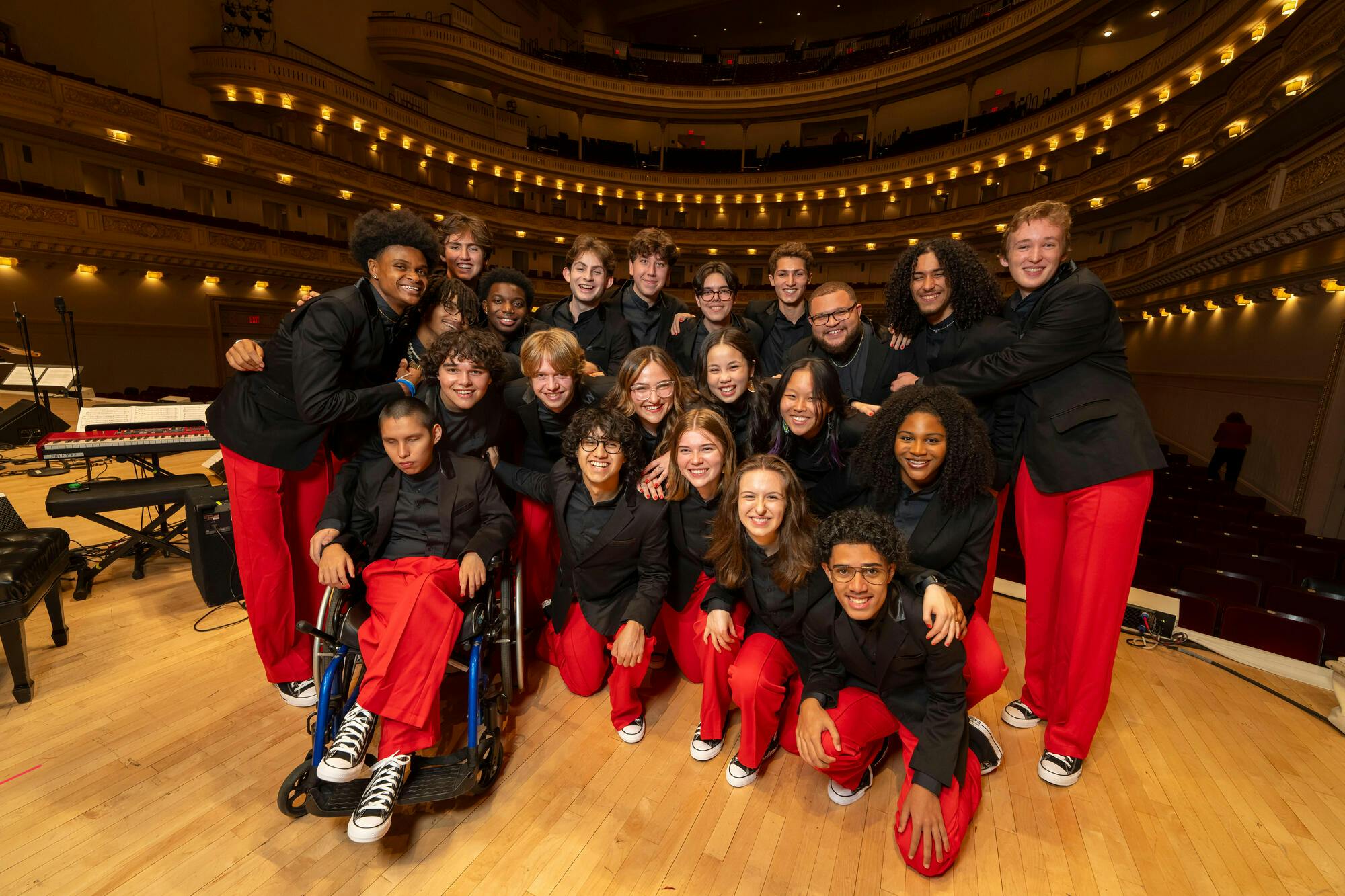 The 2024 NYO Jazz Band pose together on stage at Carnegie Hall