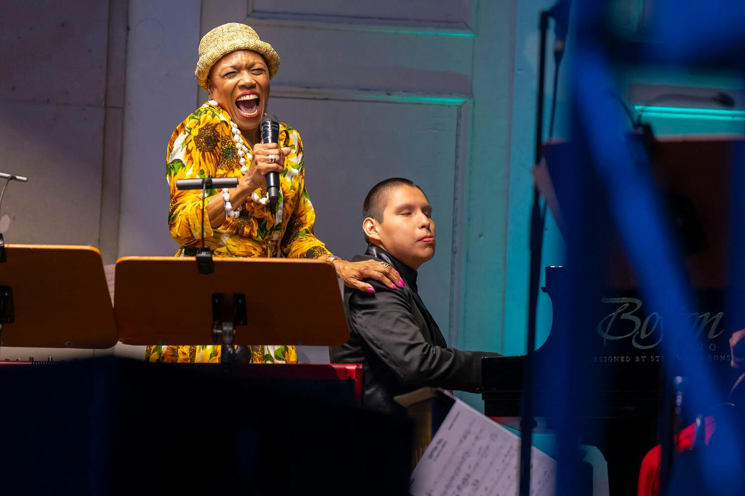 Dee Dee Bridgewater sings, hand on José André Montaño's shoulder as he plays piano