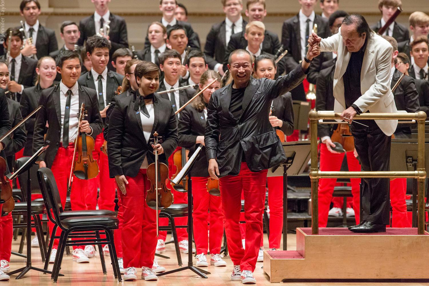 Tan Dun waves from stage with NYO-USA musicians