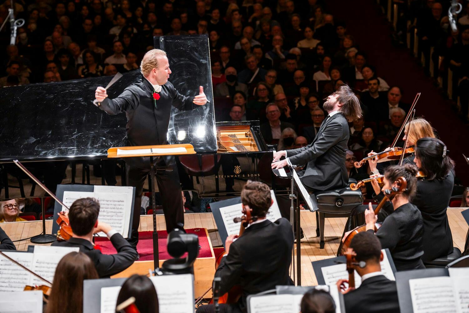 Yannick Nézet-Séguin conducts the string section as Daniil Trifonov plays piano, head thrown back