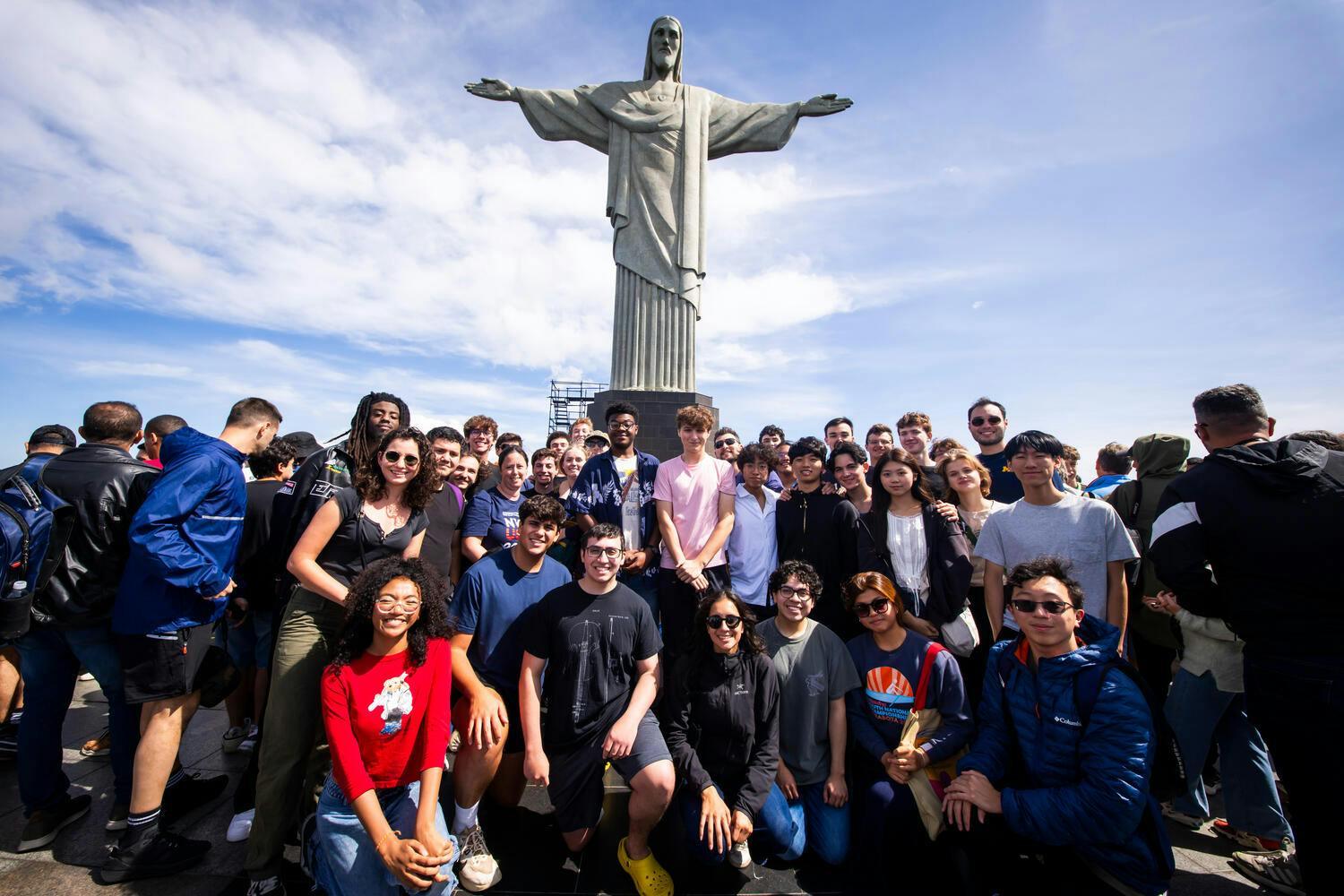 NYO-USA musicians pose before a statue of Jesus Christ
