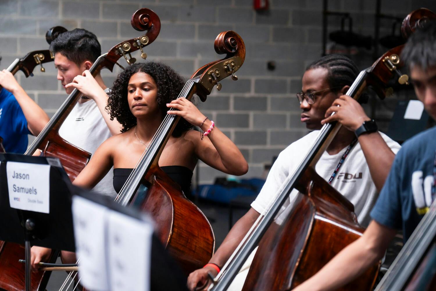 NYO2 male and female bassists perform together