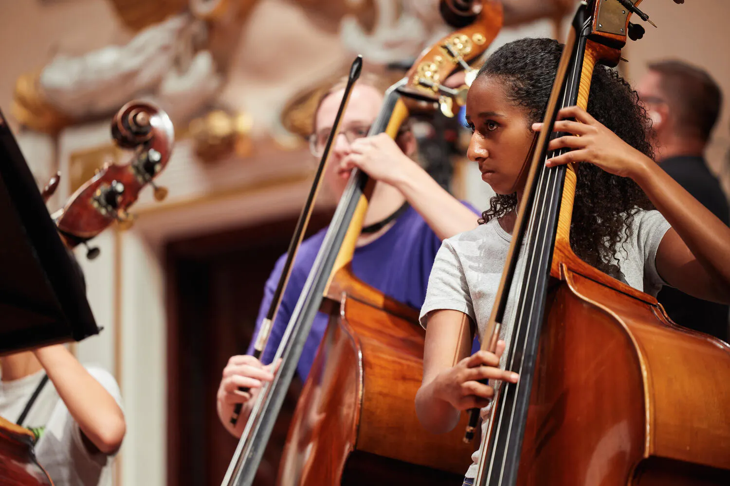 Two female NYO2 bassists rehearse