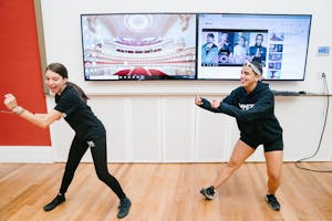 Two teenagers sway and snap in unison.