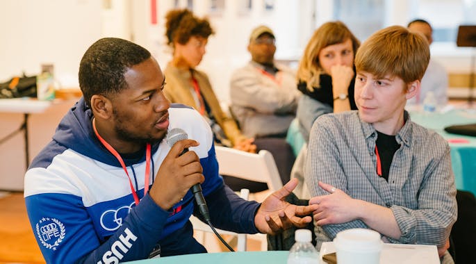 Two young men sitting at a table together