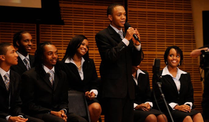 A Black, male soloist from Fisk Jubilee Singers onstage in Zankel Hall