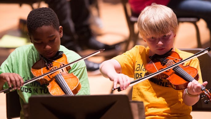 Two boys play violin