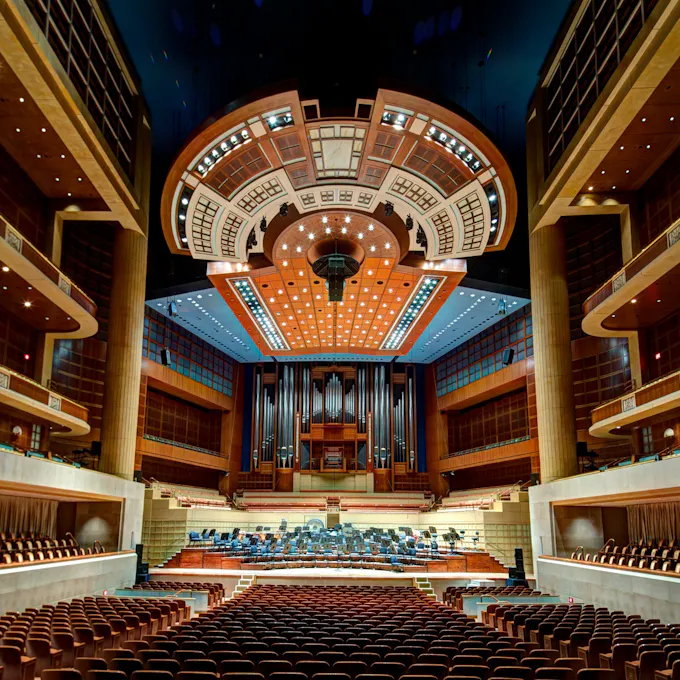View of a pipe organ on stage from the audience