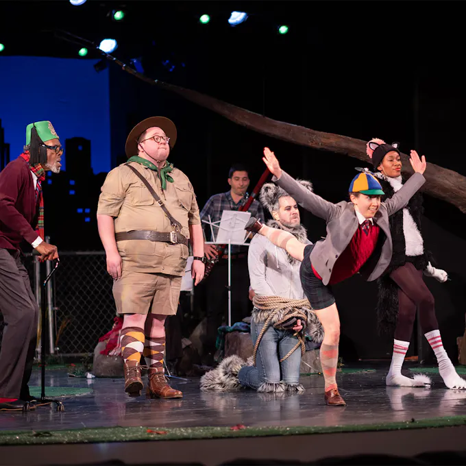 Performers in costume and musicians on stage