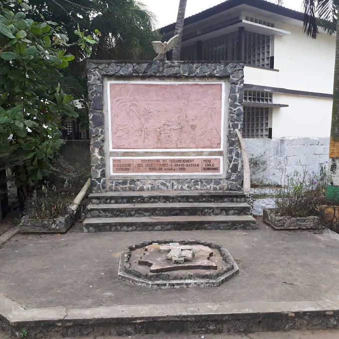 A stone memorial with steps surrounded by trees