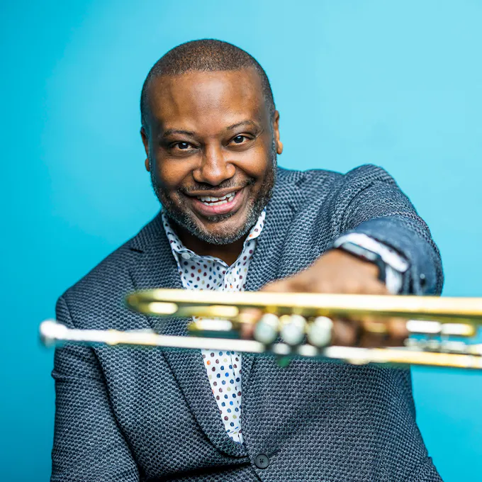 Sean Jones holding out trumpet