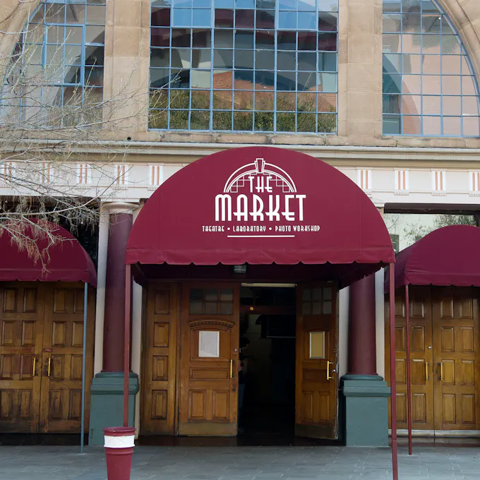 The Market Theatre with red awnings over oak doors