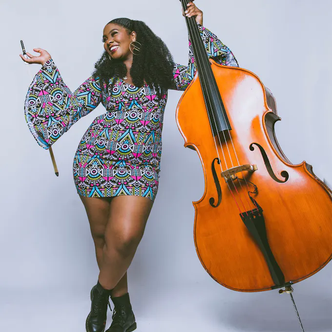 Endea Owens holding an acoustic bass