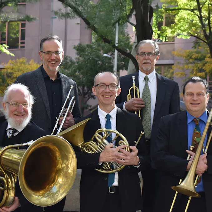 Five members of the Symphonic Brass Alliance standing with their instruments