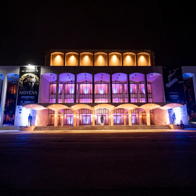 A concert hall lit with pink and orange lights
