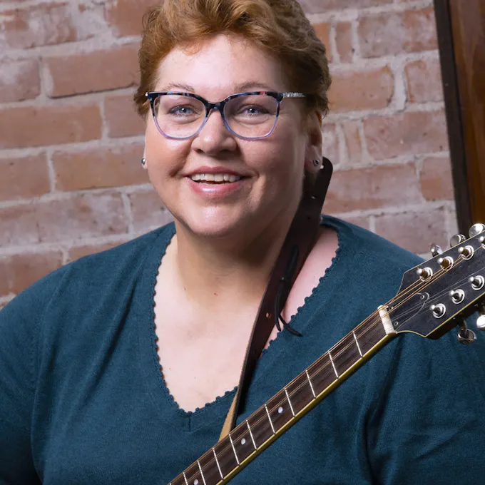 Colleen Cleveland holding a guitar