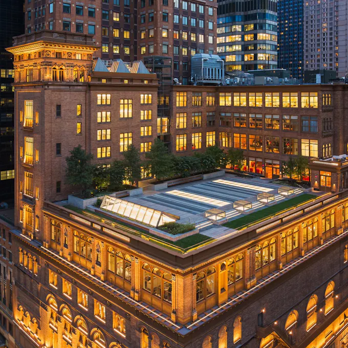 Carnegie Hall lit up at night with an overhead view of the rooftop terrace