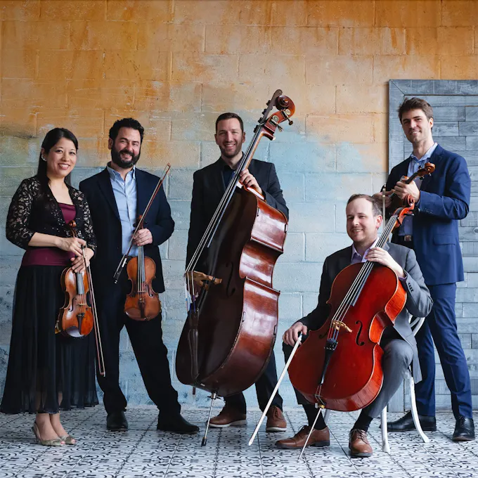 The musicians of Toomai String Quintet pose together with their instruments