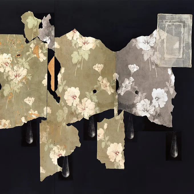 Floral wallpaper scraps on a black background