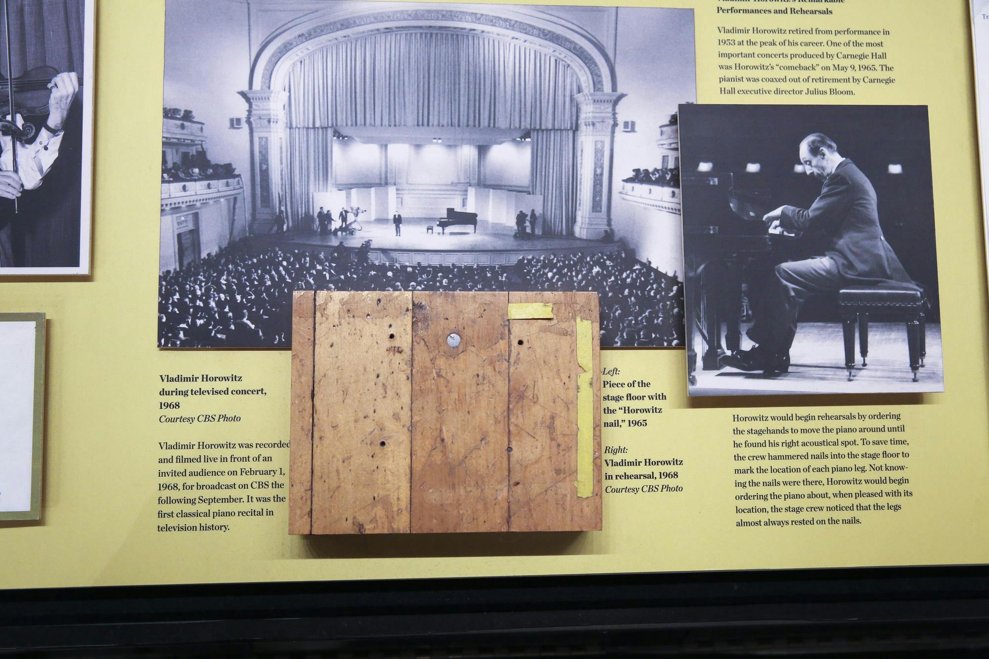 Photograph of a screw driven into the wood stage of Carnegie Hall to mark where Horowitz liked to have his piano positioned