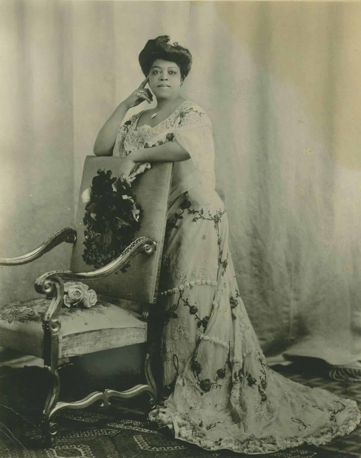 A posed photo of soprano Sissieretta Jones in a gown.