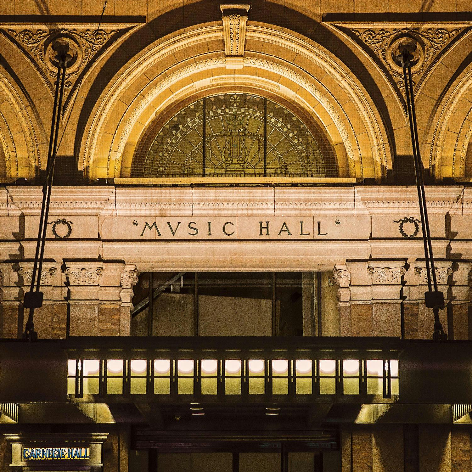 Photograph of the architectural detail of the 57th Street façade, showing a restored fanlight