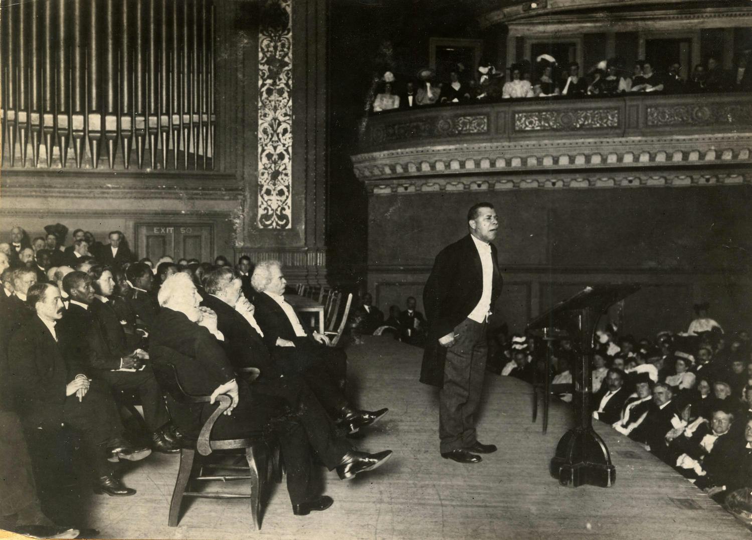 Photo of Booker T. Washington speaking at a benefit for the Tuskegee Institute, 1906