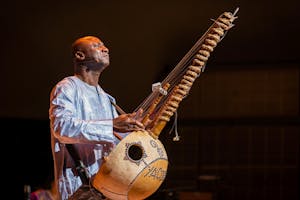 Yacouba Sissoko closes his eyes as he plays the kora, a string instrument built from a gourd.