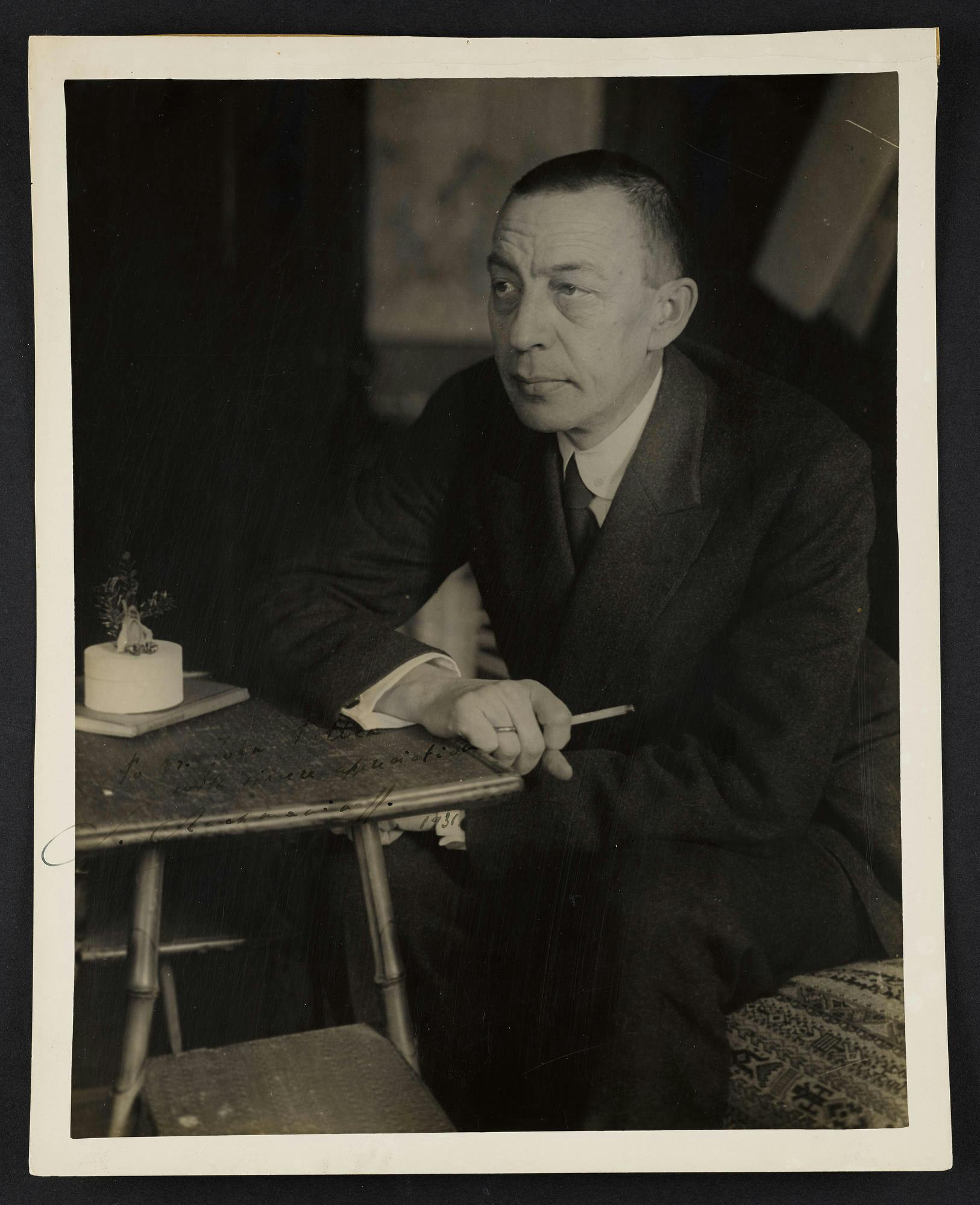 Photo of Sergei Rachmaninoff seated at a desk, 1931