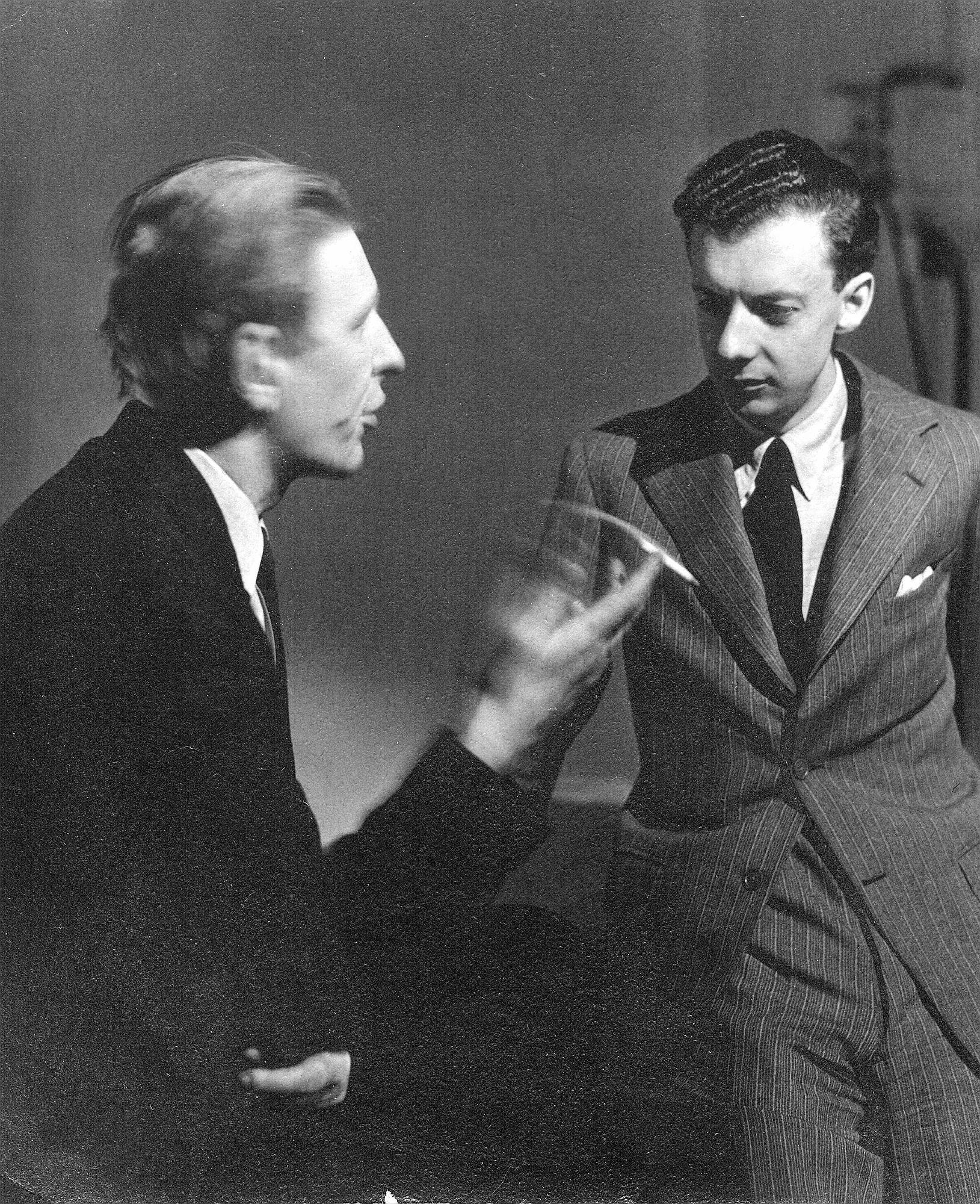 Benjamin Britten talking with W. H. Auden, who is gesturing with a cigarette