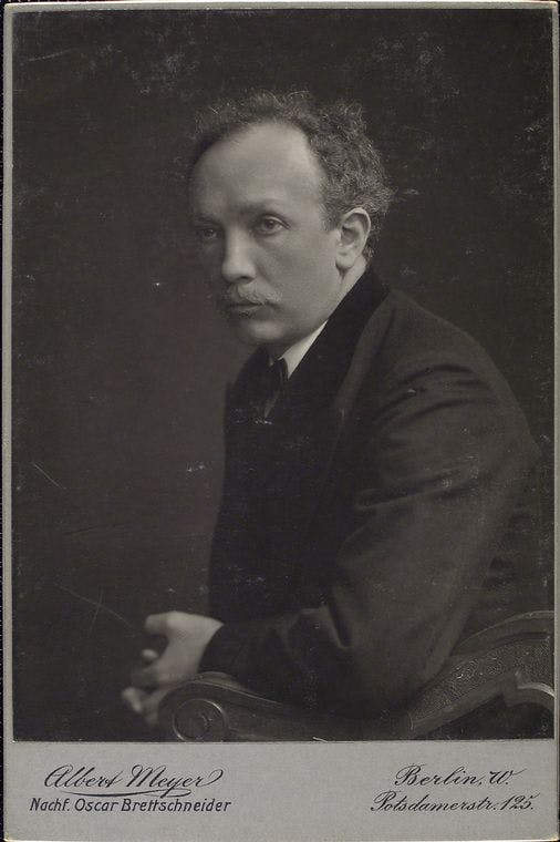 Low-contrast black-and-white photo of Richard Strauss in a black jacket and white shirt